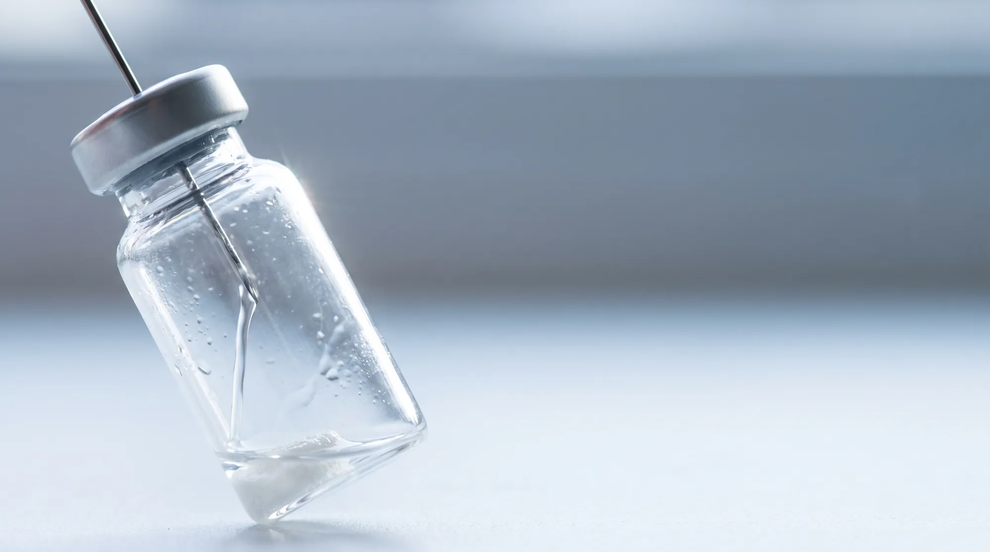 Bacteriostatic water running down the inner wall of a 3 mL glass vial